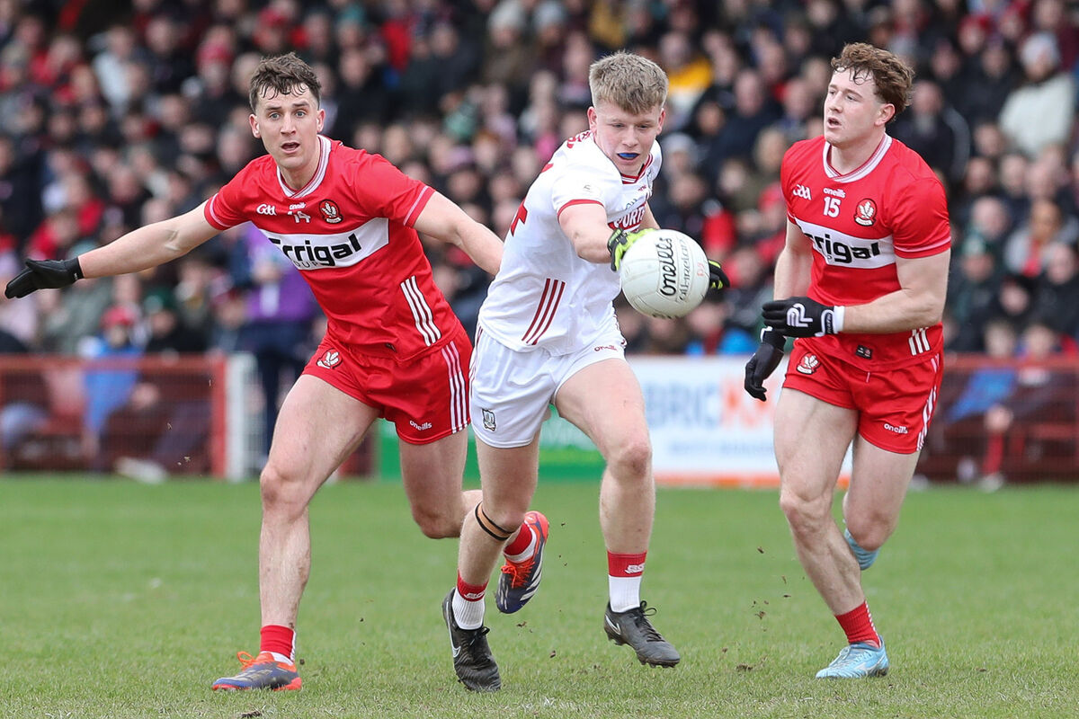Cork’s Dara Sheedy with Derry’s Shane McGuigan and Matthew Downey. Pic: Lorcan Doherty/Inpho