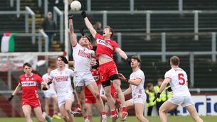 <p>Cork's Seán Walsh and Derry's Brendan Rogers contest a high ball. Pic: INPHO/Lorcan Doherty</p> <p>Cork's Seán Walsh and Derry's Brendan Rogers contest a high ball. Pic: INPHO/Lorcan Doherty</p>