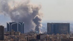 <p>Plumes of smoke rise following reported explosions in Tehran. Picture: ATTA KENARE / AFP via Getty Images</p>