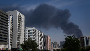 <p>A cyclist rides past as black plume of smoke is seen rising from a warehouse at the industrial area of Sharjah City in the United Arab Emirates following reports of Iranian strikes in Dubai. Picture: AP Photo/Altaf Qadri)</p> <p>A cyclist rides past as black plume of smoke is seen rising from a warehouse at the industrial area of Sharjah City in the United Arab Emirates following reports of Iranian strikes in Dubai. Picture: AP Photo/Altaf Qadri)</p>
