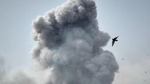 <p>A bird flies by a plume of smoke rising after a strike in Tehran, Iran, Monday, March 2, 2026. (AP Photo/Vahid Salemi)</p>