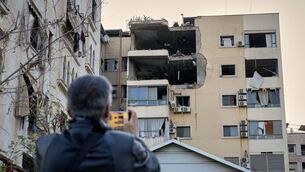 <p>A man takes pictures of the damage in an apartment building after it was hit by an Israeli airstrike in Dahiyeh, Beirut's southern suburb, Lebanon. Picture: AP Photo/Hussein Malla</p>