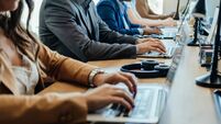 Close Up Photo of Business People Hands Using Laptop Computers in Open Plan Office