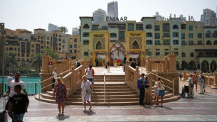 <p>Tourists at the Dubai Fountain in Dubai, United Arab Emirates, on Tuesday. Picture: Fatima Shbair/AP</p>