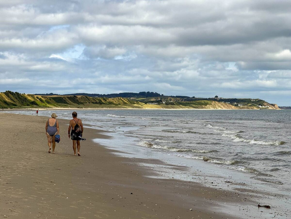 People taking a pleasant walk along a beach in Wexford. People taking a pleasant walk along a beach in Wexford.