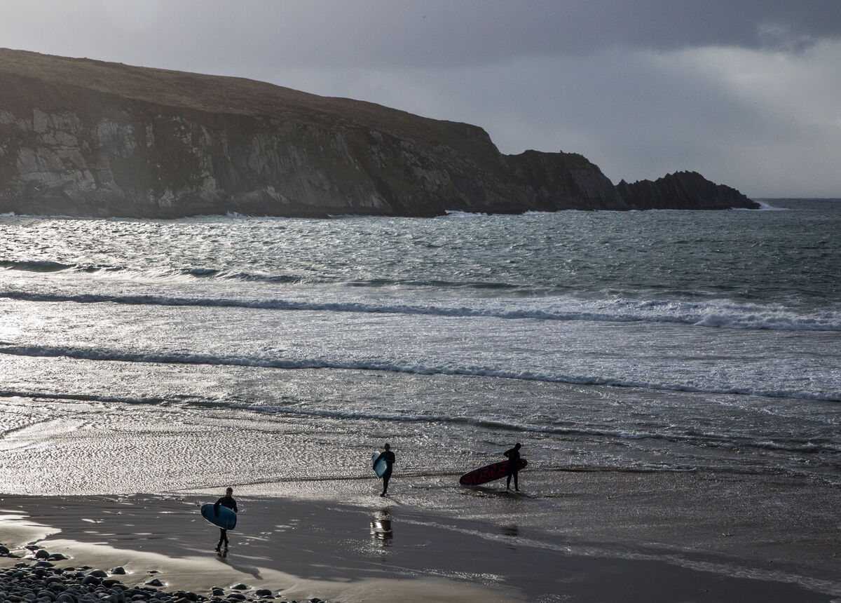  Chimney Cove, Cork.  Three young surfers carry their boards along the beach after finishing surfing at Chimney Cove, Barleycove, Co. Cork, Ireland. - Picture David Creedon