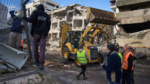 <p>Rescue workers and military personnel work at the scene of a direct hit a day after an Iranian missile struck in Tel Aviv, Israel, Sunday, March 1, 2026. (AP Photo/Oded Balilty)</p>