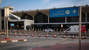 <p>A police vehicle and an ambulance are parked on the departure road of the Dubai International Airport as it lies deserted following its closure in Dubai, United Arab Emirates, Sunday, March 1, 2026. (AP Photo/Altaf Qadri)</p>