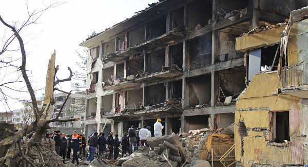 Turkish police officers and members of rescue services work at the destroyed police station in Cinar. Pic: AP Turkish police officers and members of rescue services work at the destroyed police station in Cinar. Pic: AP