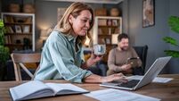Woman working from home enjoying coffee with husband