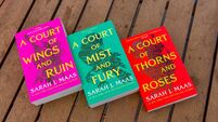 Close-up of Sarah J. Maas's A Court of Wings and Ruin, A Court of Mist and Fury, and  A Court of Thorns and Roses fantasy novels