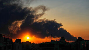 <p>The sun sets behind a plume of smoke rising after a U.S/Israeli military strike in Tehran, Iran, Tuesday, March 3, 2026. (AP Photo/Vahid Salemi)</p>