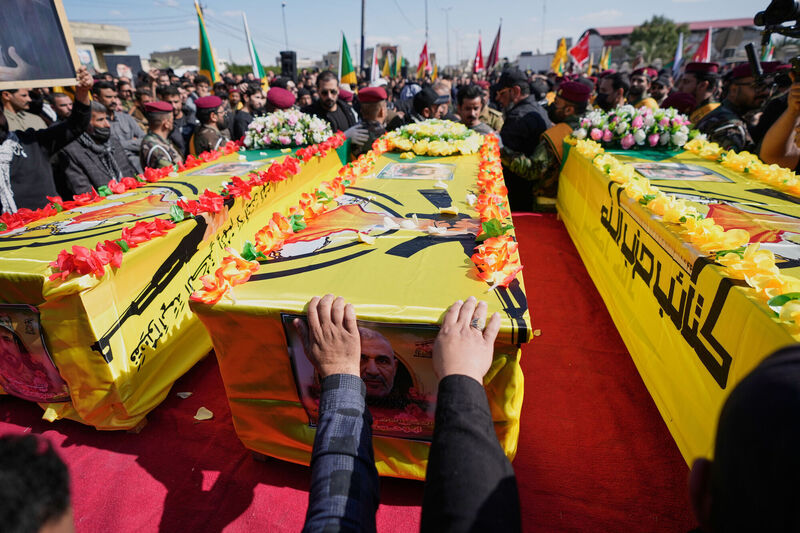Members from the Popular Mobilization Forces attend the funeral of fighters from Kataib Hezbollah, who were killed in a U.S. airstrike in Babil province southwest of Baghdad, Iraq, Thursday, March 5, 2026. (AP Photo/Hadi Mizban)