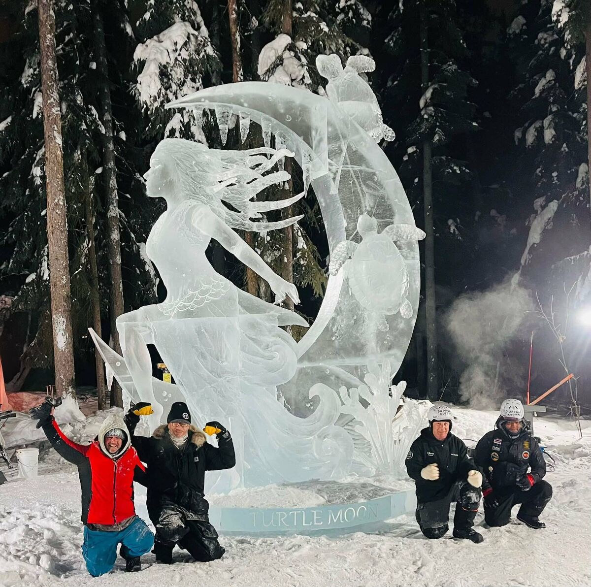 John Hayes (left) with his teammates next to an ice sculpture he made at the World Ice Art Championships in Fairbanks, Alaska.