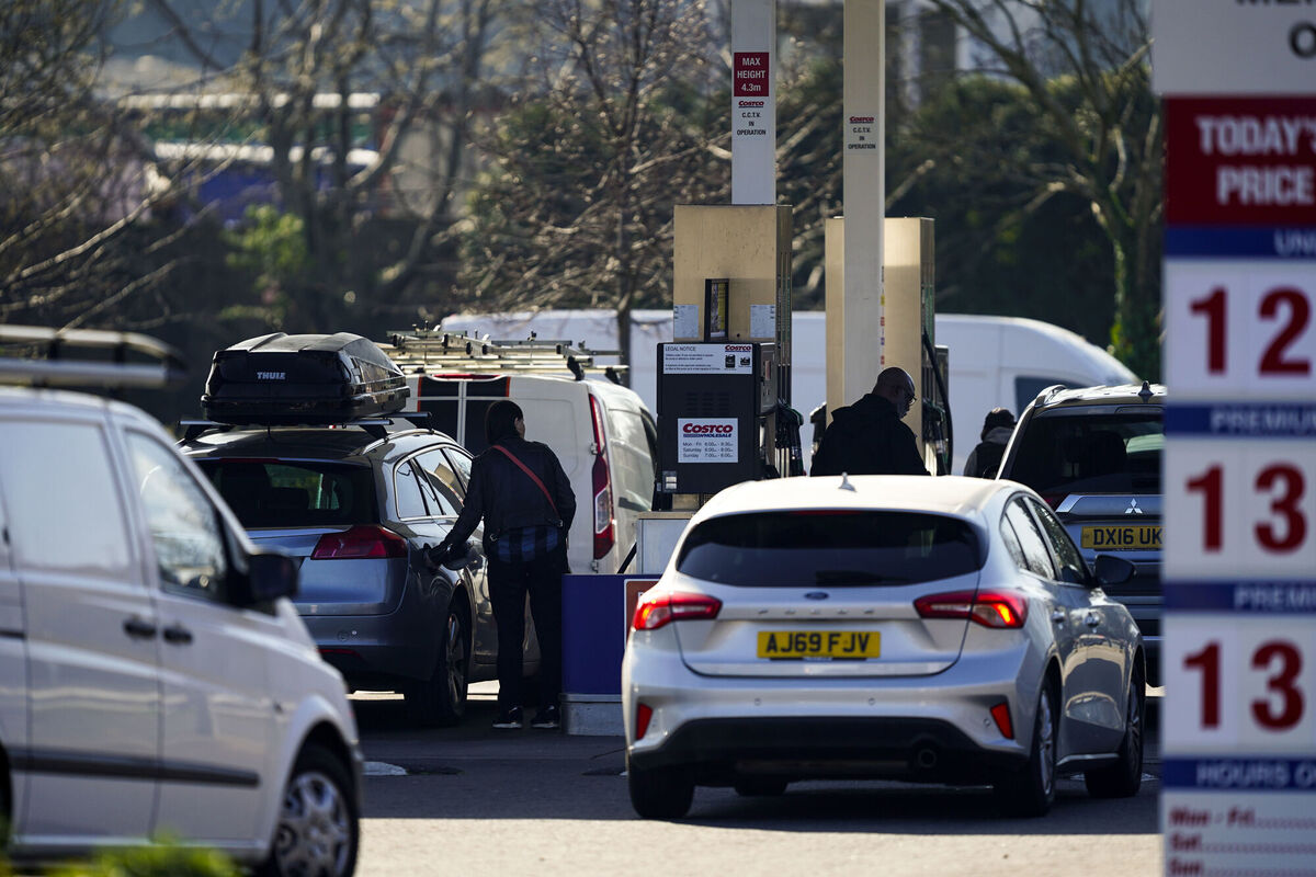 People dispense fuel at a pump England during the week amid the US/Israeli war in Iran.