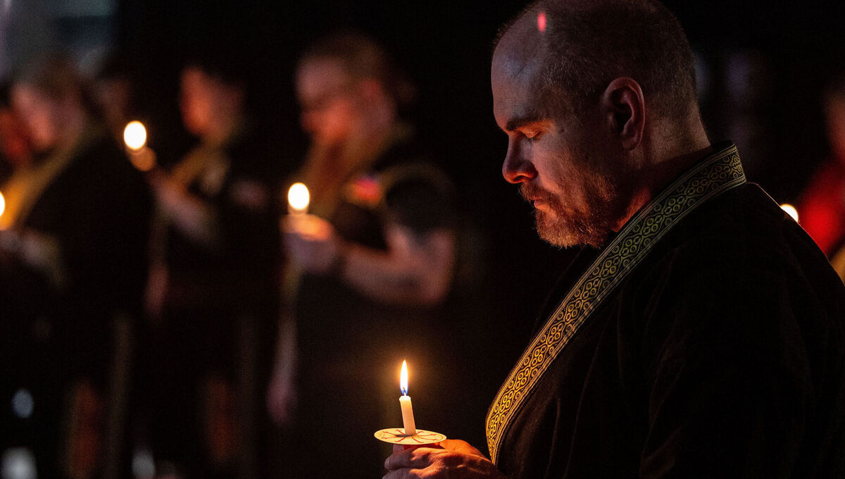 People bow their heads for a moment of silence during a candlelight mat ceremony for former student and instructor Noah Tietjens, who was killed in a drone strike at a command center in Kuwait, at Martial Arts International in Nebraska on Thursday. Picture: Chris Machian/Omaha World-Herald via AP