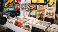 Vinyl records in a record shop, Pop music posters