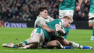 <p>GOING DOWN FIGHTING: Ireland's Jamie Osborne, right, hits the deck before scoring Ireland's fourth try. Pic: Brian Lawless/PA</p>