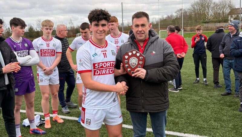 Cork captain Joe Miskella with the title after defeating Louth. Picture: Max Ricken