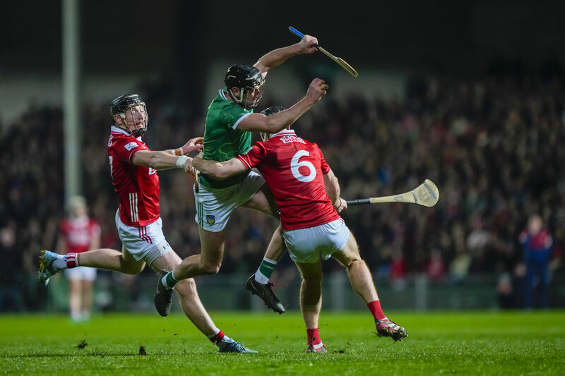 TUSSLE: Diarmaid Byrnes of Limerick is fouled by Eoin Downey of Cork. Pic ©INPHO/James Lawlor