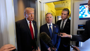 <p>President Donald Trump speaks to reporters as White House Special Envoy to the Middle East Steve Witkoff, center, and Defense Secretary Pete Hegseth listen while traveling aboard Air Force One en route from Dover Air Force Base, Del., to Miami. Picture: AP Photo/Mark Schiefelbein</p>
