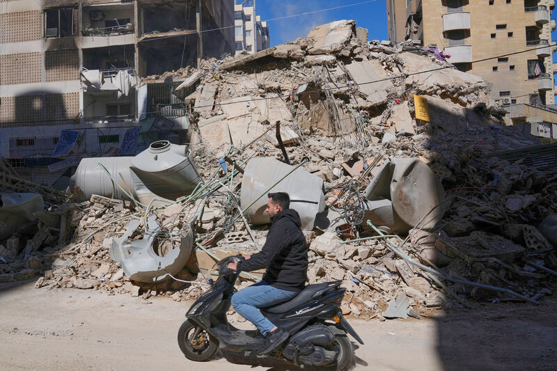 A man rides a scooter past a building that was destroyed by an Israeli airstrike in Dahiyeh, Beirut's southern suburbs, Lebanon, Sunday, March 8, 2026. Picture: AP Photo/Hussein Malla
