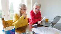 Senior couple checking financial documents at home