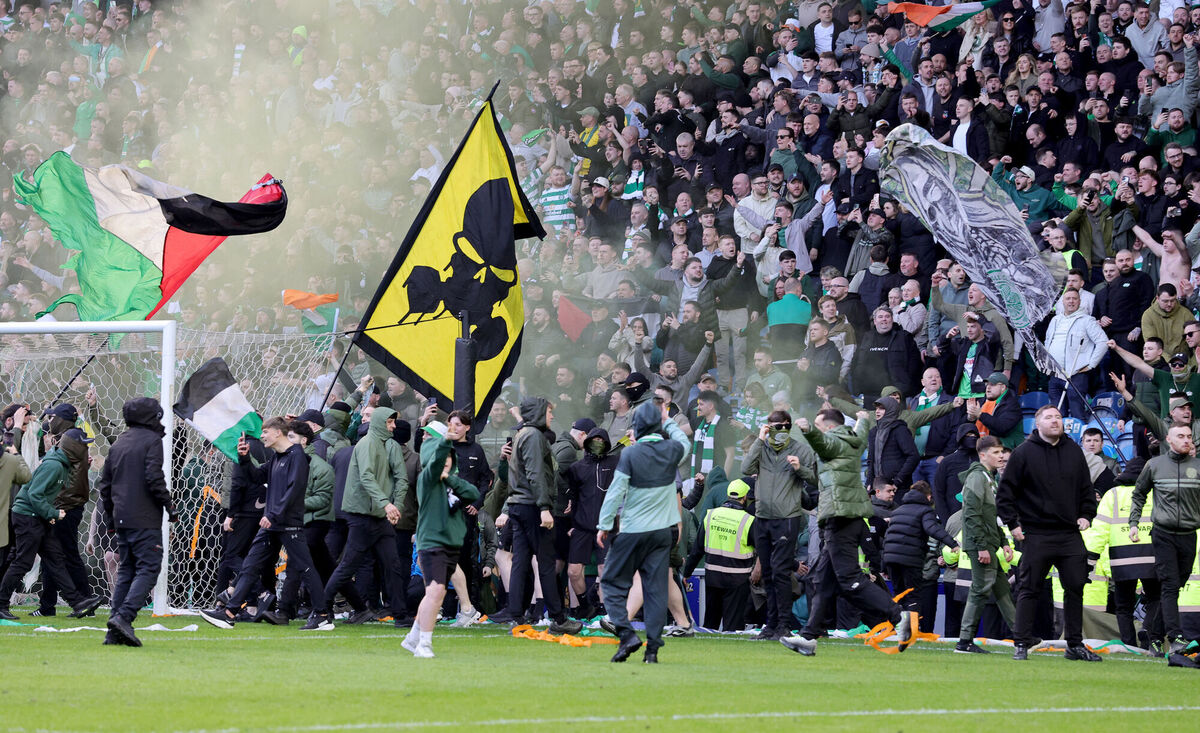 Celtic fans spill onto the pitch following their teams win. Pic: Steve Welsh/PA Wire.