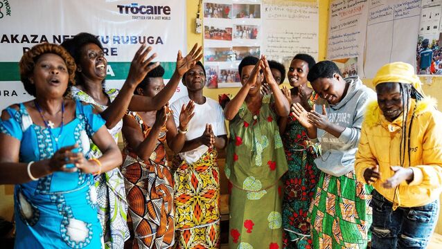 <p>Women dancing at the Rulindo Rwanda Women’s Network building (Brian Lawless/PA)</p>