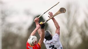 <p>Paddy Boland of Carlow catches the ball behind Kildare full back Rian Boran.</p>