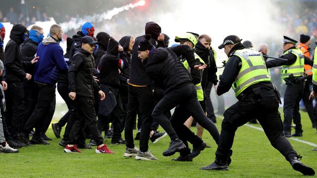FLASHPOINT: Police officer and stewards force fans back after they invaded the pitch following a penalty shoot out after the Scottish Gas Men's Scottish Cup quarter-final match at Ibrox Stadium, Glasgow. Pic: Steve Welsh/PA Wire <p>FLASHPOINT: Police officer and stewards force fans back after they invaded the pitch following a penalty shoot out after the Scottish Gas Men's Scottish Cup quarter-final match at Ibrox Stadium, Glasgow. Pic: Steve Welsh/PA Wire</p>