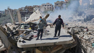 <p>People examine the wreckage of houses in Sir al-Gharbiyeh village, south Lebanon on Sunday after Israeli air strikes as the conflict expanded across the Middle East. Picture: Mohammed Zaatari/AP</p>