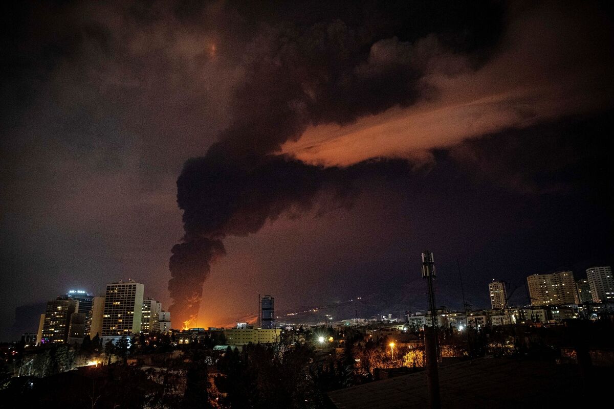 Flames and smoke rise from an oil storage facility struck in Tehran late on Saturday amid US–Israeli attacks on Iran. Picture: Arileza Sotakbar/ISNA/AP