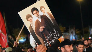 <p>Iraqis hold a portrait of the late Iran’s Supreme Leader Ayatollah Ali Khamenei and his son Ayatollah Mojtaba Khamenei (Hadi Mizban/AP)</p>