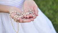 Rosary in Girl's hands