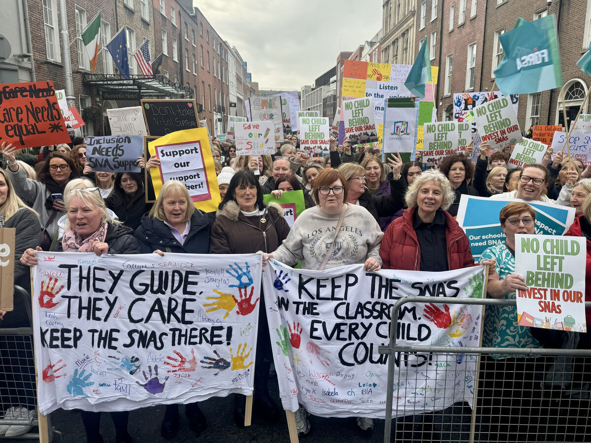 Natalie Murphy and her daughter Lily from Dublin join special needs assistants in a demonstration outside Leinster House in Dublin last month.