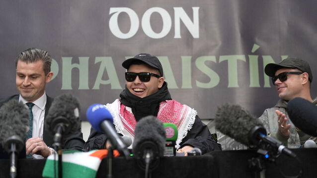 <p>Kneecap's Mo Chara, Móglaí Bap, and their lawyer Darragh Mackin during a press conference in Belfast on Wednesday. Picture: Niall Carson/PA</p>